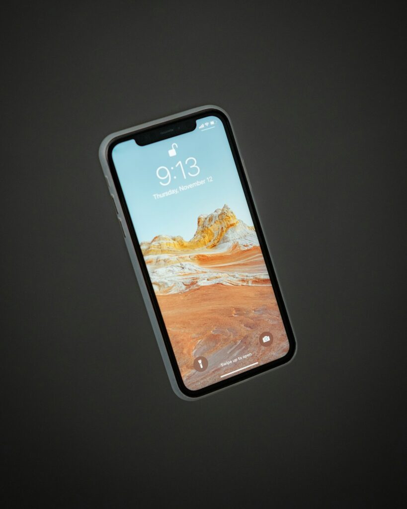 Hand holding iPhone displaying app